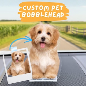 May include: A custom pet bobblehead of a small, light brown dog with a pink tongue sticking out. The bobblehead is on a dashboard, with a photo of the dog in a polaroid frame. The text "CUSTOM PET BOBBLEHEAD" is in a yellow banner.