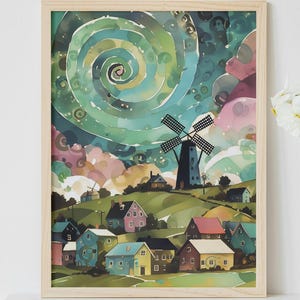 May include: Watercolor painting of a village with a windmill under a swirling green and blue sky. The artwork is framed in light wood and features colorful houses and rolling hills. A vase of white flowers sits beside the framed art.