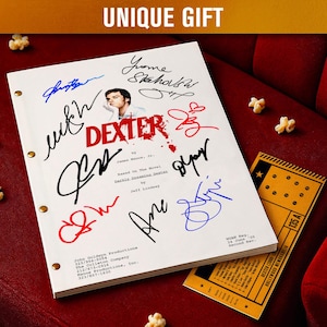 May include: A white script with the title "DEXTER" in red, featuring multiple signatures and a headshot. A yellow ticket and popcorn are on a red velvet surface. The text "UNIQUE GIFT" is at the top.