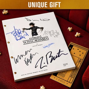 May include: A film script for "Edward Scissorhands" with signatures, a cinema ticket, and popcorn on a red velvet surface. The script cover features an illustration of the character and the film's title.