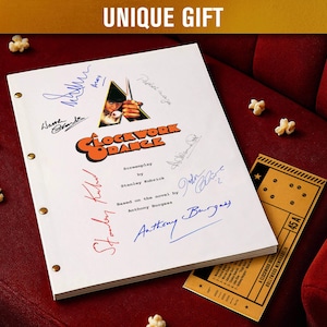May include: A white screenplay titled "Clockwork Orange" with multiple signatures, a movie ticket, and popcorn on a red seat. The screenplay is based on the novel by Anthony Burgess.