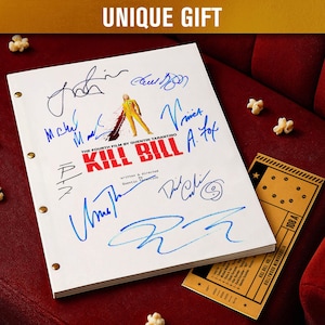 May include: A white movie script titled "Kill Bill" with multiple signatures in blue ink. The script is open, revealing the title and a small illustration. A vintage movie ticket and popcorn are also visible.