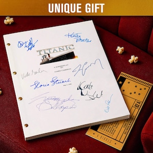 May include: A white screenplay titled "Titanic" with multiple signatures in blue ink, a movie ticket, and popcorn on a red velvet surface. The text "UNIQUE GIFT" is at the top.