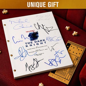 May include: A film script for "The Dark Knight" with signatures in blue and black ink, on a red surface. Popcorn and a movie ticket are also present. The text "UNIQUE GIFT" is at the top of the image.