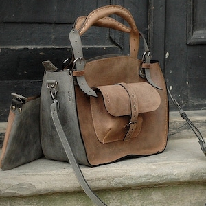 Very stylish gray and brown ahoulder bag with cluth bag and large pocket on the outside
