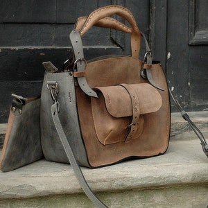 Very stylish gray and brown ahoulder bag with cluth bag and large pocket on the outside