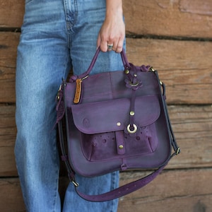 Plum handbag with top handle.