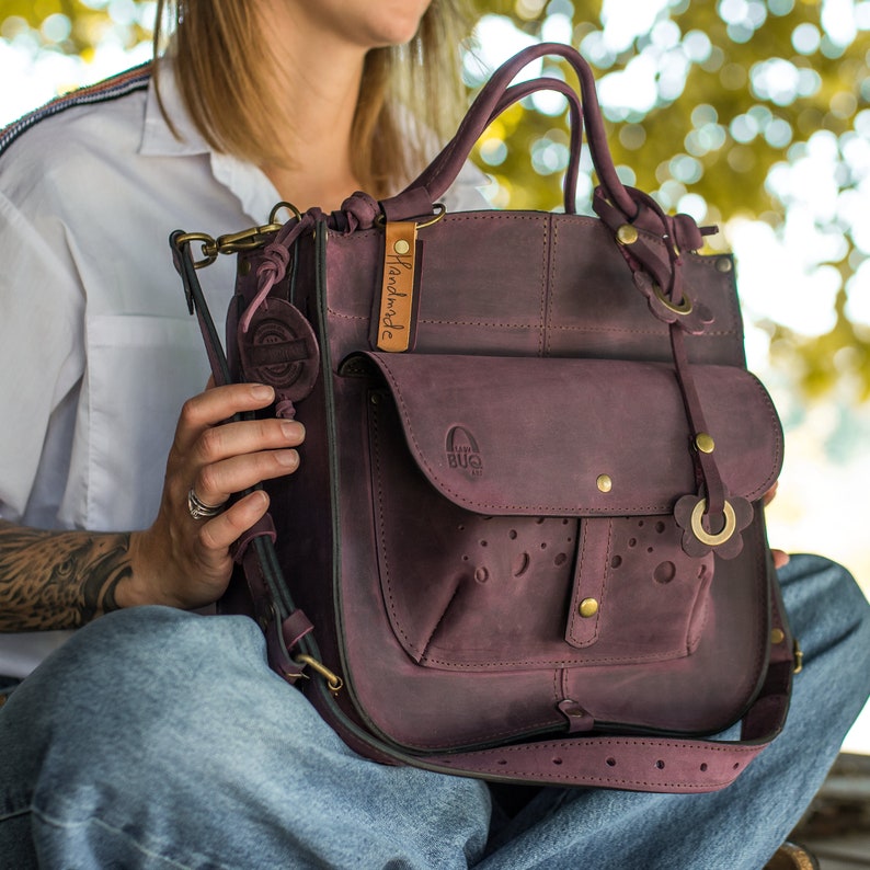 Leather handbag with a large decorative pocket