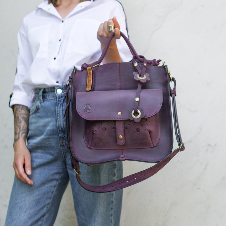 Shopper leather bag made from beautiful natural leather plum color. Bag is made from beautiful thick leather. Outside big has large roomy pocket with flap. Bag is stiff, bag has crossbody strap and original handles.