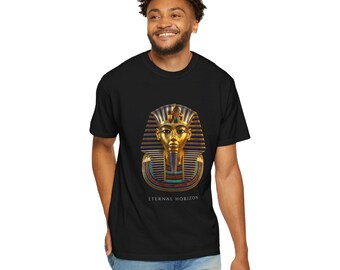 May include: A black short-sleeve t-shirt featuring a centered graphic of the golden funerary mask of Tutankhamun with blue and gold striped details. Below the mask, the text ETERNAL HORIZON is printed in a clean, white, sans-serif font.