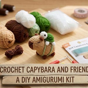 May include: A crochet kit for making a capybara and turtle amigurumi. The kit includes balls of yarn in various colours, stuffing, crochet hooks, and a pattern. The finished capybara is tan with a green turtle.
