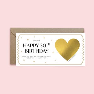 May include: A rectangular white scratch-off birthday card with a gold foil heart, gold star accents, and a scalloped border. The text reads: TO OLIVIA, HAPPY 30TH BIRTHDAY, HOPE YOU HAVE AN AMAZING BIRTHDAY, LOVE YOU LOTS, JAMIE XX, and SCRATCH TO REVEAL.