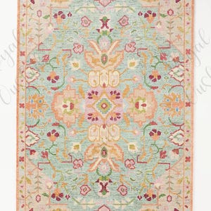 May include: A rectangular rug with a light blue background and a floral pattern in shades of pink, orange, and green. The rug has a border in a similar color palette. The design is symmetrical and features stylized flowers and leaves.