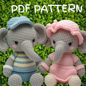 May include: Two crocheted elephant dolls, one in blue and yellow striped clothing with a blue cap, the other in a pink dress and hat. The dolls are gray with pink cheeks and are set against a green leafy background. The words "PDF PATTERN" are at the top.