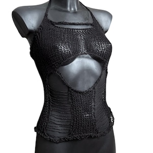 May include: Black halter top with an open-weave design. The top has a chest cutout and a distressed, shredded appearance. The garment is displayed on a black mannequin.