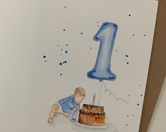May include: A watercolour greeting card illustration featuring a small child in a blue shirt reaching towards a two-tiered brown birthday cake with a single lit candle. Above the cake floats a large blue balloon shaped like the number one.