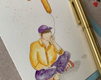 May include: A watercolour illustration on white paper featuring a person in a yellow shirt, purple trousers, and a purple cap sitting down. A yellow balloon shaped like the number seven floats above, connected by a thin string. A gold pen lies nearby.
