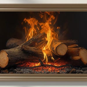 May include: A rectangular wall art piece featuring a framed image of a burning campfire. The scene displays stacked brown logs with bright orange and yellow flames rising from the center, set against a dark background with glowing embers below.