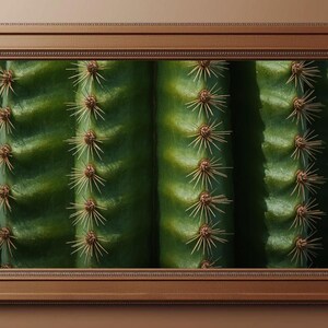 May include: A rectangular wall frame with a brown finish containing a close-up photograph of green cactus columns. The image displays vertical ridges and sharp, light-colored spines arranged in rows along the surface of the plant.