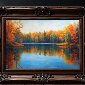 Puede incluir: Pintura de paisaje enmarcada que representa una serena escena lacustre con vibrante follaje otoñal. La obra presenta un lago reflectante que refleja los coloridos árboles en tonos naranja, amarillo y verde. El marco ornamentado, de color marrón oscuro, añade un toque clásico.