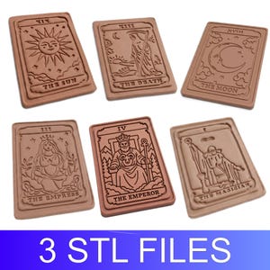May include: Six rectangular light brown plaques featuring embossed tarot card designs including The Sun, The Death, The Moon, The Empress, The Emperor, and The Magician. Each plaque displays Roman numerals and text labels at the top and bottom.