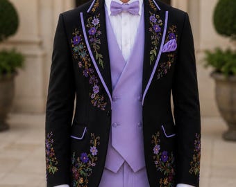 May include: A black blazer featuring purple floral embroidery and lavender piping, worn over a lavender double-breasted vest, a white dress shirt, and a lavender bowtie, paired with matching lavender trousers and a lavender pocket square.