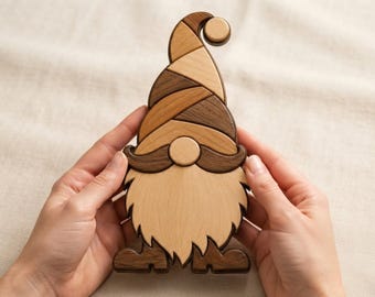 May include: A wooden gnome figurine crafted from multiple pieces of light and dark wood. The gnome features a tall, curved hat, a round nose, a wide mustache, and a long, pointed beard, all assembled with visible seams between the wood segments.