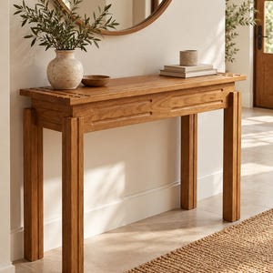 May include: A rectangular wooden console table with four straight legs, featuring a light brown finish and a slatted top design. The table has two horizontal rectangular panels on the front apron and a smooth, flat surface for display items.