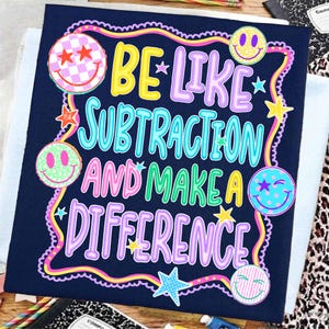 May include: A dark blue fabric square featuring the colourful text BE LIKE SUBTRACTION AND MAKE A DIFFERENCE. The design includes various smiley faces with checkered, dotted, and striped patterns, along with small star shapes in a wavy border.