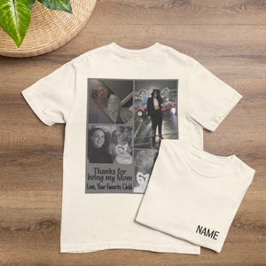 May include: Off-white t-shirt with a collage of black and white photos and the text "Thanks for being my Mom Love, Your Favorite Child." A second folded t-shirt is next to it with the word "NAME" printed on it.