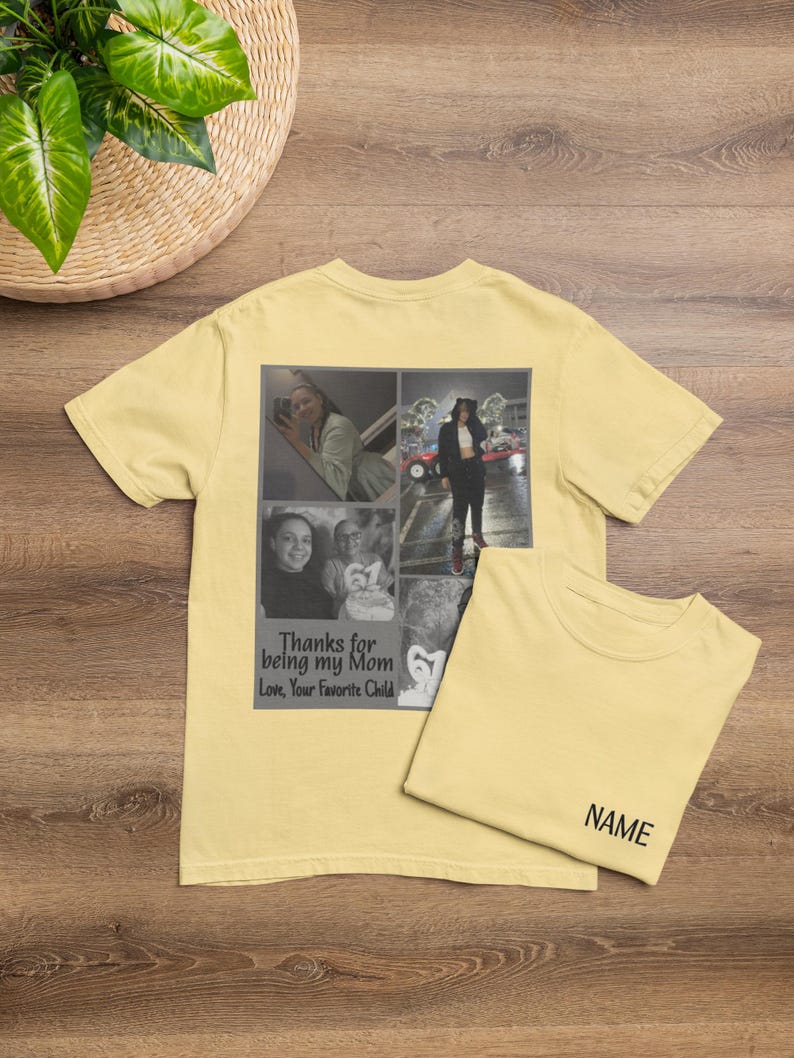 May include: A light yellow t-shirt with a photo collage and text that reads "Thanks for being my Mom, Love, Your Favorite Child." A second t-shirt is folded next to it with the word "NAME" printed on it. The shirts are on a wooden surface.