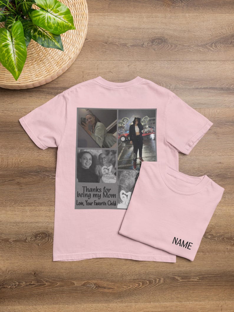May include: A light pink t-shirt with a collage of photos and the text "Thanks for being my Mom Love, Your Favorite Child." A second t-shirt is folded next to it with the word "NAME" printed on it.