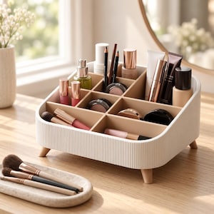 May include: A white ribbed cosmetic organizer with multiple compartments, standing on four small light wood legs. The organizer holds various makeup items including lipsticks, brushes, tubes, and compacts. A separate oval tray holds three makeup brushes.