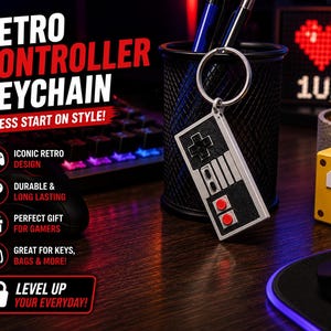 May include: A retro controller keychain with a silver finish, black buttons, and red accents. The keychain is hanging in front of a black pen holder. Text on the image reads "Retro Controller Keychain" and "Press Start on Style!"