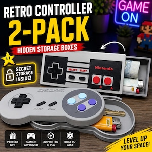 May include: A two-pack of retro video game controller storage boxes. One rectangular box resembles an original NES controller with a sliding compartment containing items. The other oval box resembles a Super Nintendo controller with a hinged lid.