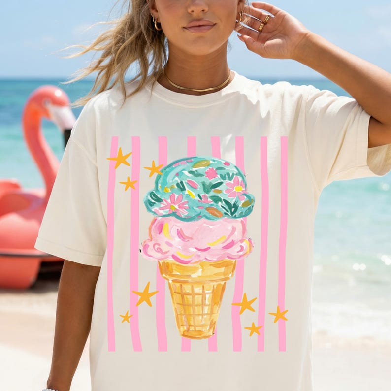 Retro pastel striped png featuring double scoop pastel ice cream cone top scoop has floral pattern and bottom scoop is pink.  Background stripes are pink yellow stars scattered.   Shown here on woman at the beach wearing a white oversized tee.