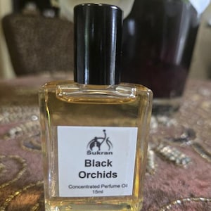 May include: A small glass bottle of concentrated perfume oil labelled "Sukran Black Orchids Concentrated Perfume Oil 15ml".