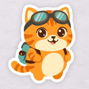 May include: A cartoon sticker of an orange tabby cat wearing aviator goggles and a teal backpack. The cat has big brown eyes and a small pink tongue sticking out. The cat is smiling and appears to be ready for an adventure.
