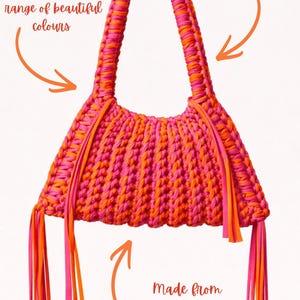 May include: A handmade, two-tone pink and orange Frankie bag made from recycled t-shirt yarn. The bag features a braided handle and decorative tassels. The text on the image says the handles are customizable and available in a range of colors.