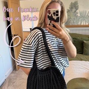 May include: Black Frankie bag with a braided strap and fringe detail. The bag is made of a thick, textured material. The text "Our Frankie bag in Black" is visible in the image.