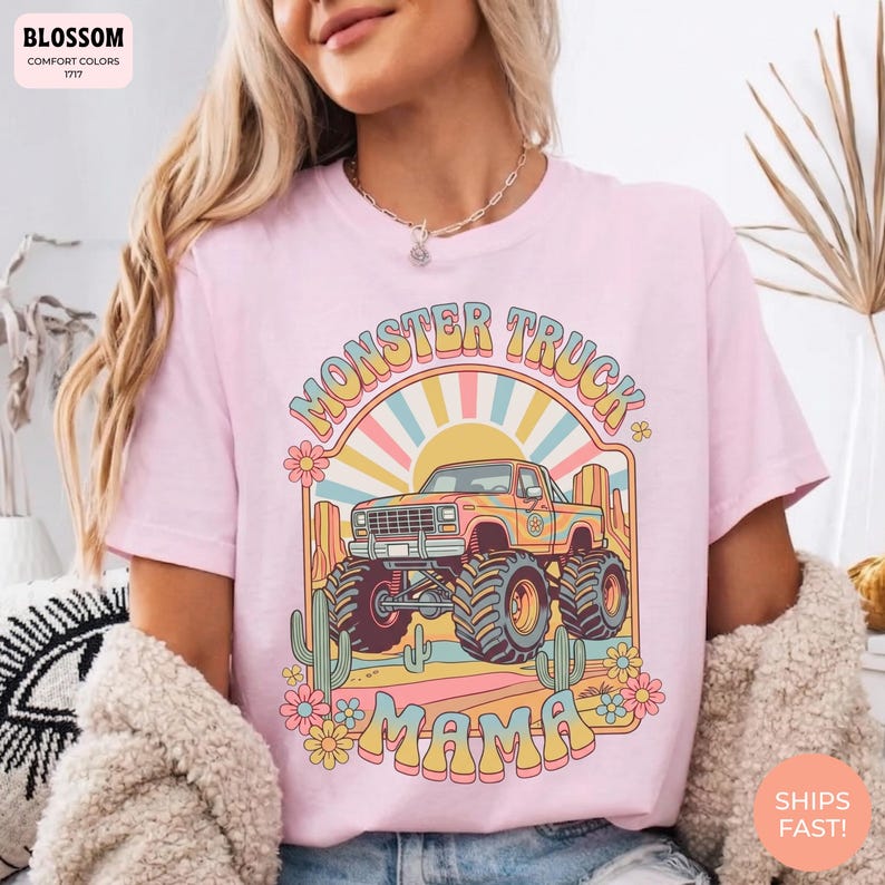 Comfort Colors graphic tee featuring a retro groovy monster truck with floral details, desert cacti, and a sunburst backdrop, arched text reading Monster Truck Mama, designed for moms of boys, Monster Jam fans, and birthday party season.