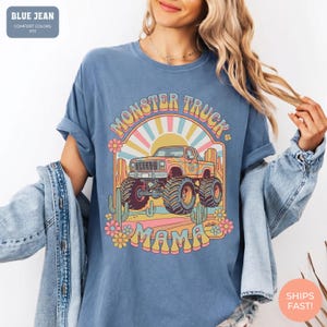 Comfort Colors graphic tee featuring a retro groovy monster truck with floral details, desert cacti, and a sunburst backdrop, arched text reading Monster Truck Mama, designed for moms of boys, Monster Jam fans, and birthday party season.
