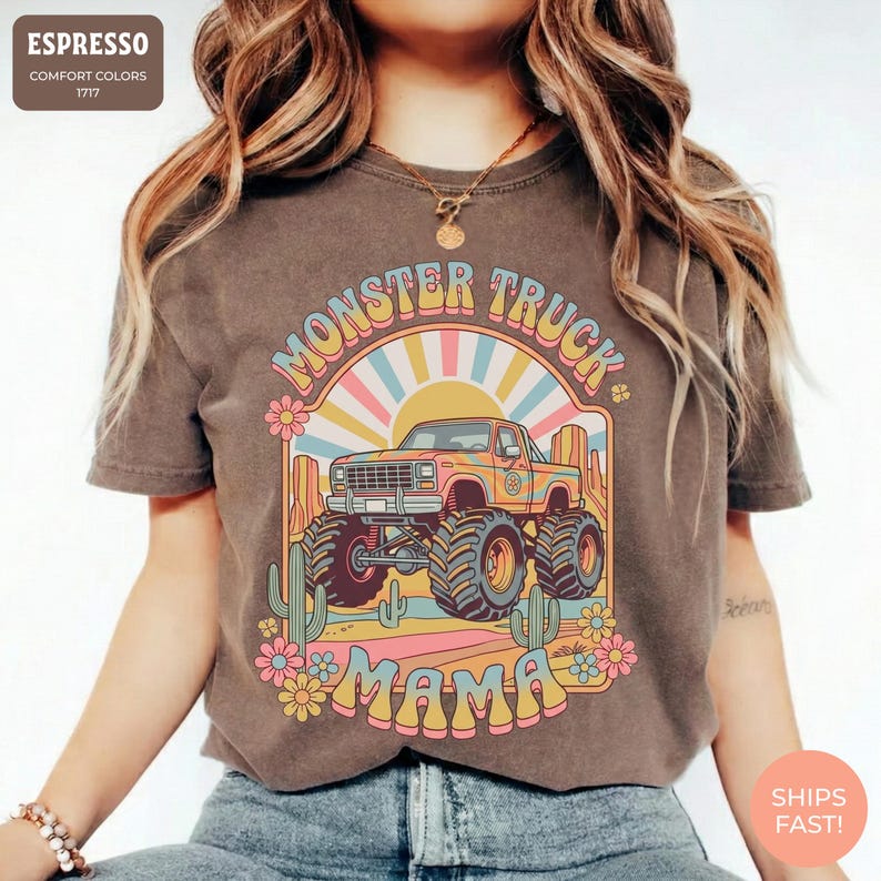 Comfort Colors graphic tee featuring a retro groovy monster truck with floral details, desert cacti, and a sunburst backdrop, arched text reading Monster Truck Mama, designed for moms of boys, Monster Jam fans, and birthday party season.