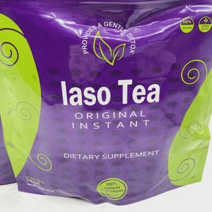 Pode incluir: Uma embalagem roxa de suplemento alimentar "laso Tea". A embalagem tem detalhes verdes com espirais e as palavras "ORIGINAL INSTANT" em branco. A embalagem tamb&eacute;m indica "100% ingredientes naturais".