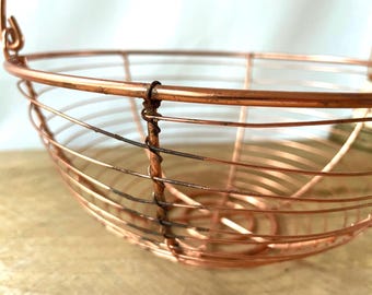 Cesta de frutas artesanal de alambre de cobre con asa giratoria, estilo rústico francés para cocina.