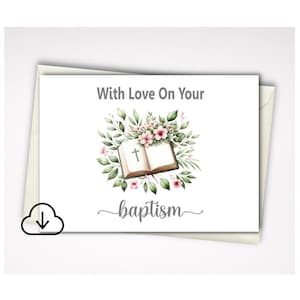 May include: A white greeting card featuring the text With Love On Your baptism in grey script and block lettering. The center illustration shows an open book with a cross symbol, surrounded by a wreath of green leaves and small pink flowers.