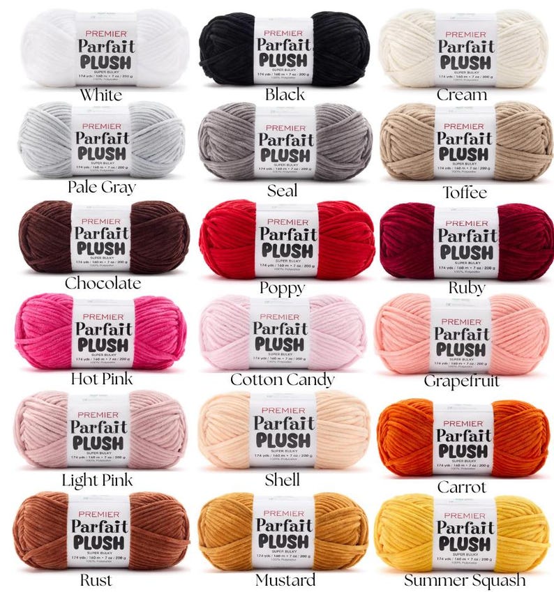 May include: A collection of Premier Parfait Plush yarn in various colors, including white, black, and cream. Each skein is labeled with its color name. The image showcases a range of hues, from pale gray to ruby, and rust to summer squash.
