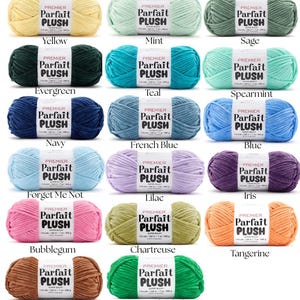 May include: A collection of Premier Parfait Plush yarn skeins in various colors, including yellow, mint, sage, evergreen, teal, spearmint, navy, French blue, blue, forget me not, lilac, iris, bubblegum, chartreuse, tangerine, teddy bear, and seaweed salad.