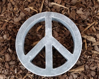 Placa con el símbolo de la paz o piedra decorativa para jardín.