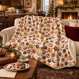 May include: A plush throw blanket featuring an all-over print of various cookies, including jam-filled thumbprints, chocolate-dipped treats, and layered bars, with a soft white sherpa fleece lining on the reverse side and folded edges.